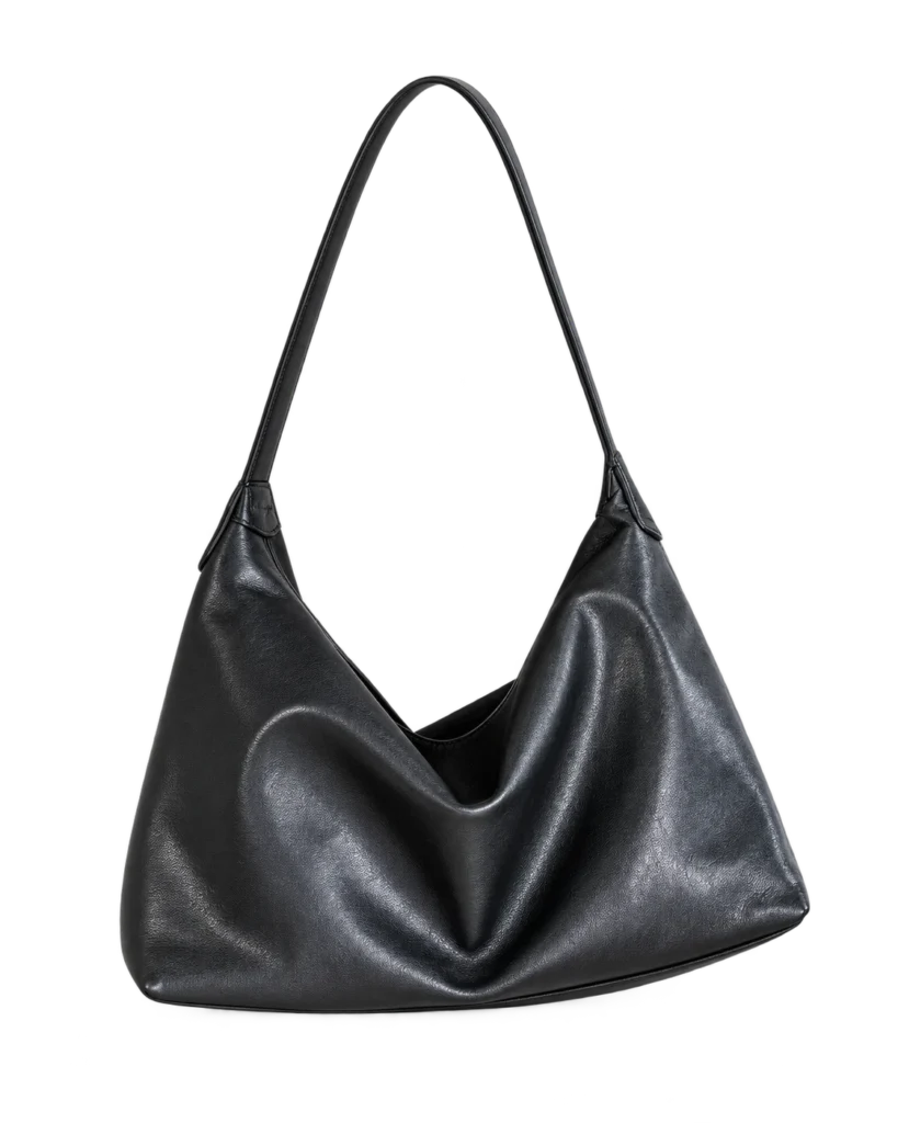 Black leather hobo bag on a pale studio background