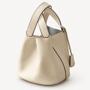 Cream grained leather bucket bag with crossed handles, side view