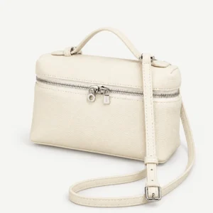 Cream leather zip-top mini bag on a pale studio background