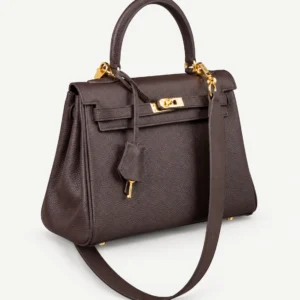 Ebony wide-strap leather top-handle bag on a pale studio background