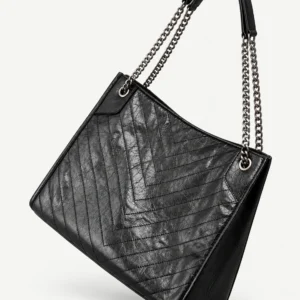 Black split-leather chain-handle hobo on a pale studio background