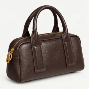 Coffee compact leather bowling bag on a pale studio background