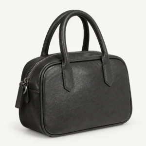 Black leather bowling bag on a pale studio background