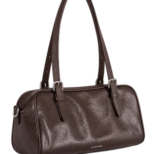 Coffee leather bowling shoulder bag on a pale studio background