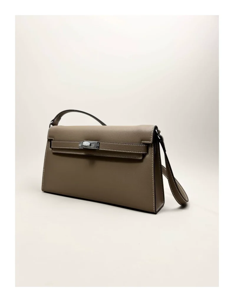 The Evening — Elongated Leather Shoulder Bag — Taupe / Silver-tone