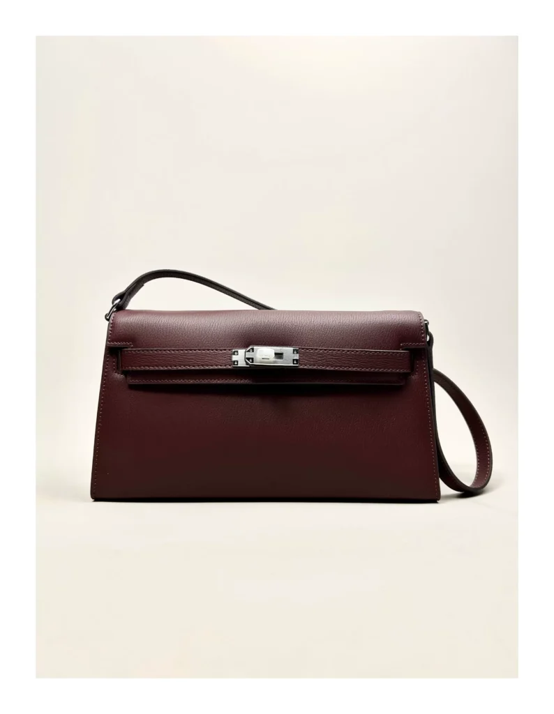 The Evening — Elongated Leather Shoulder Bag — Saddle Red / Silver-tone