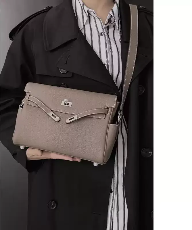 MONA STUDIO taupe textured flap messenger shoulder bag worn with a black coat